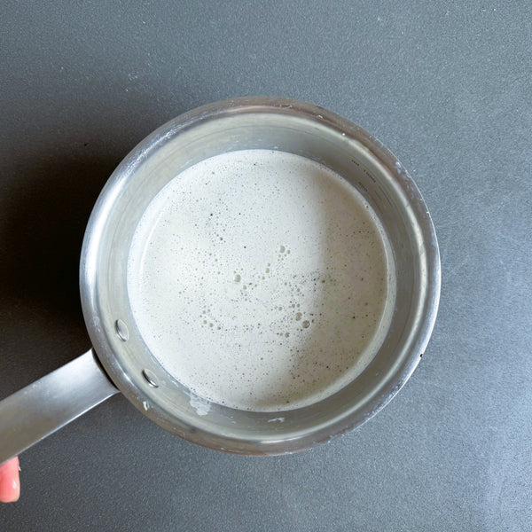 adding the black sesame mixture to a pot