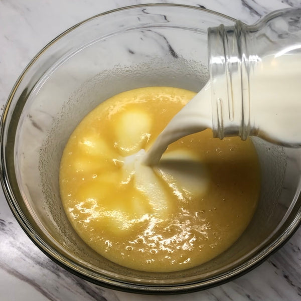adding coconut milk to the wet batter