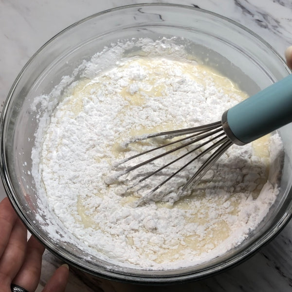 adding the mochi flour and dry ingredients to the wet batter