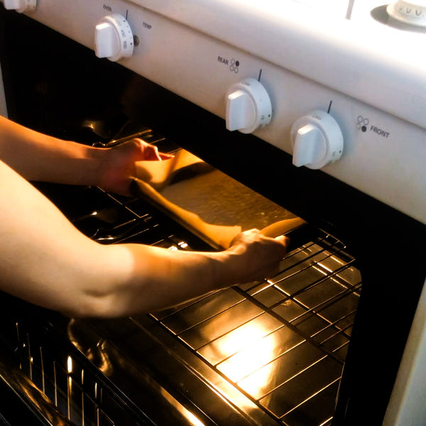 placing butter mochi into the oven