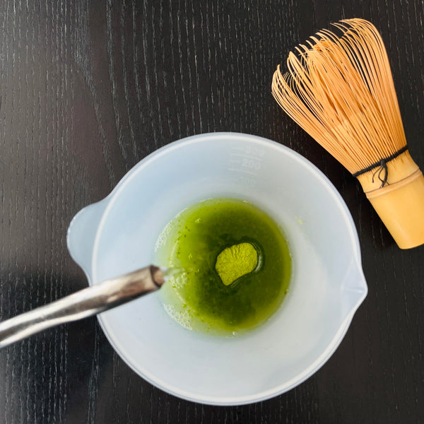 pouring hot water into the matcha