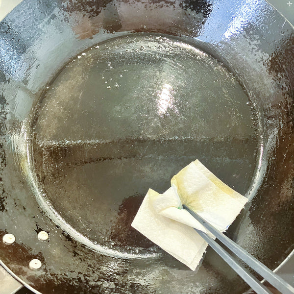 greasing the frying pan with butter