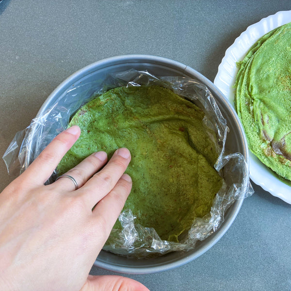 addinng the matcha crepe to the pan