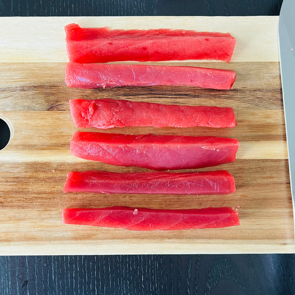 cutting the tuna into match sticks