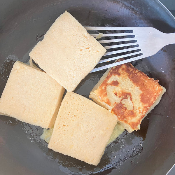 flipping the french toast and allowing it to cook on the other side