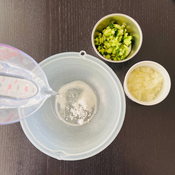 adding salt, sugar, and water to a bowl