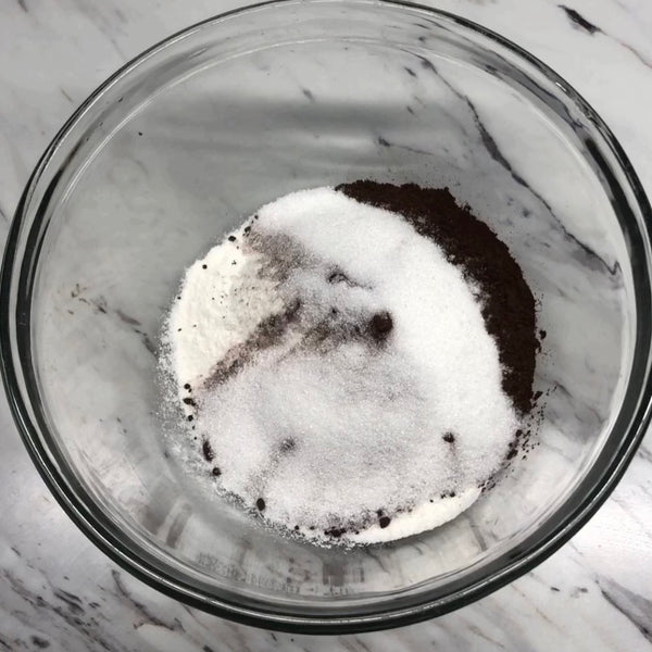 adding sugar, cocoa powder, and glutinous rice flour (mochiko) to a bowl