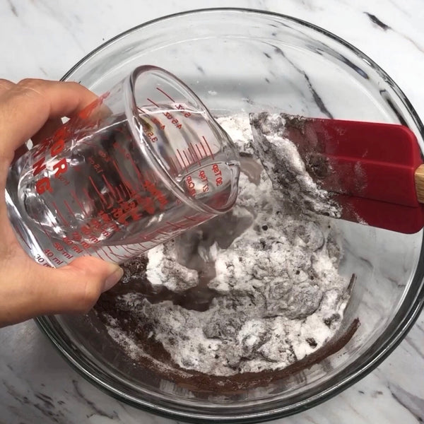 adding water to the dry ingredients