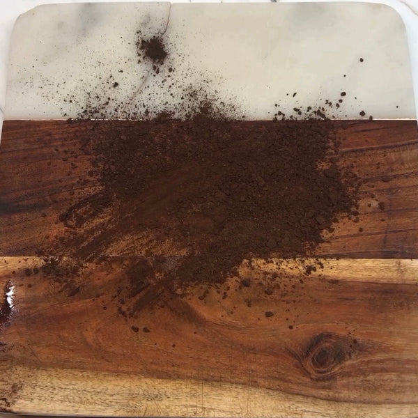 dusting a cutting board with cocoa powder