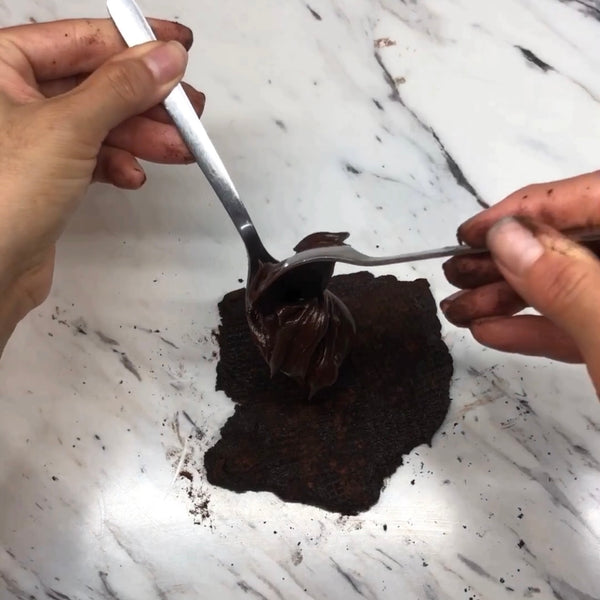 spooning the chocolate ganache into the chocolate mochi