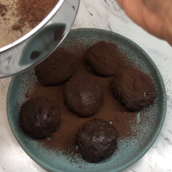 making sure each piece is evenly coated in cocoa powder