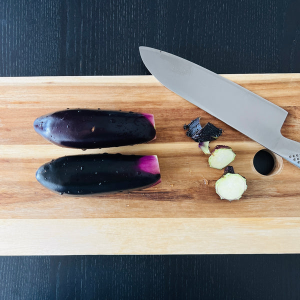 cutting the stems off of the eggplants