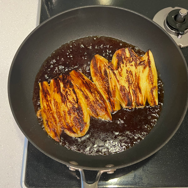 adding the sauce to the cooked eggplants