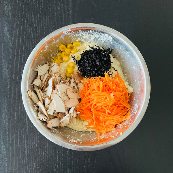 adding the vegetables, hijiki seaweed, and gingko nuts to the tofu  mixture