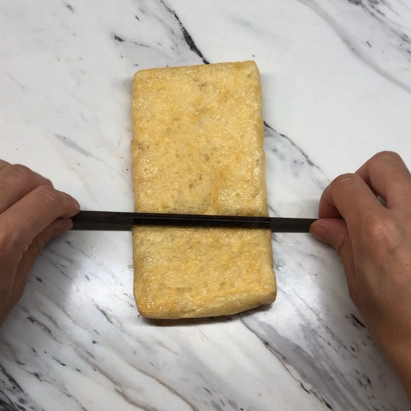 flattening the tofu pouch