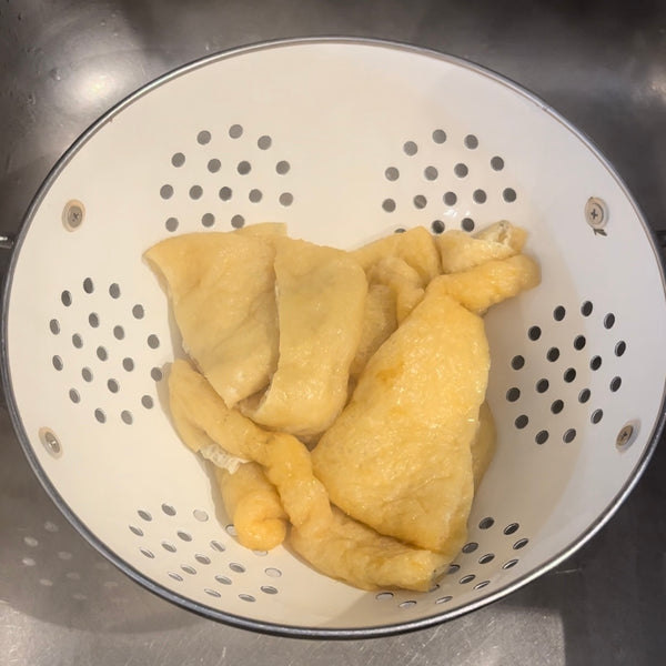 draining the boiled tofu pouches