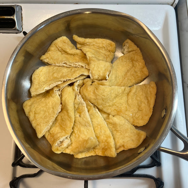 placing the tofu pouches into a clean pot