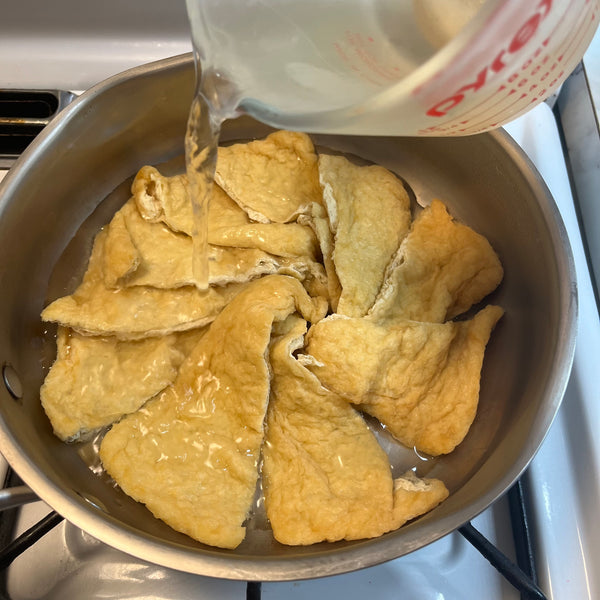 adding the seasonings to the tofu pouches