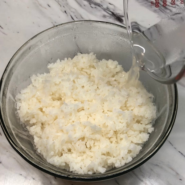 adding the sushi seasonings to the rice