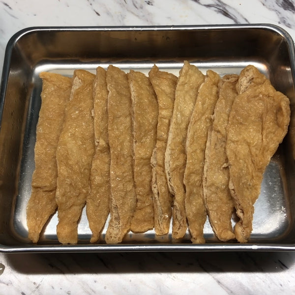 putting the tofu pouches back on the tray