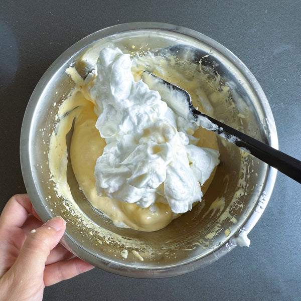 adding the meringue into the egg yolk mixture