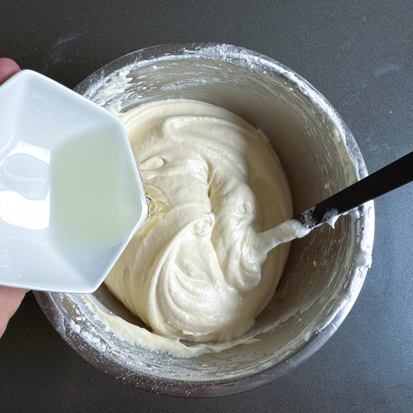 adding cooking oil to the cake batter