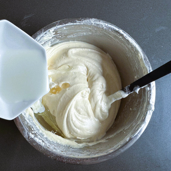 adding whole milk to the cake batter