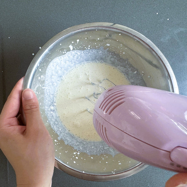 mixing the cream with a hand mixer