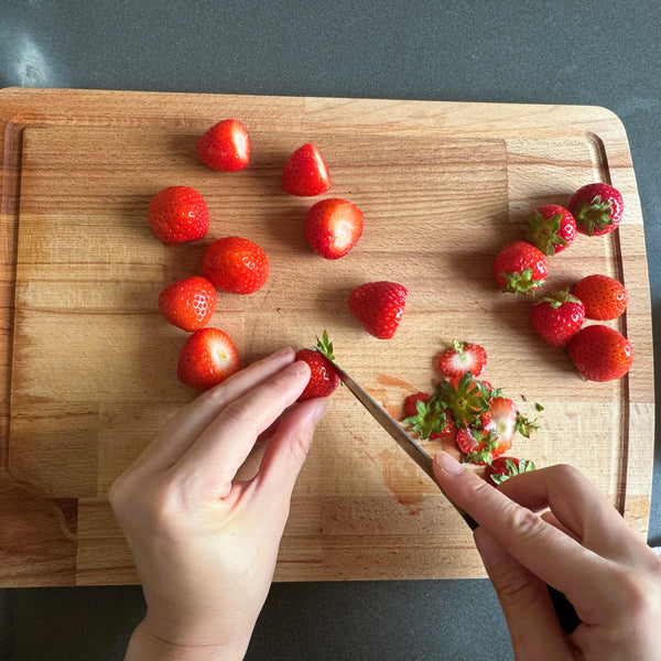 cutting the tops off the strawberries