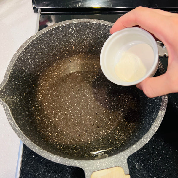 adding kanten powder to a pot of water