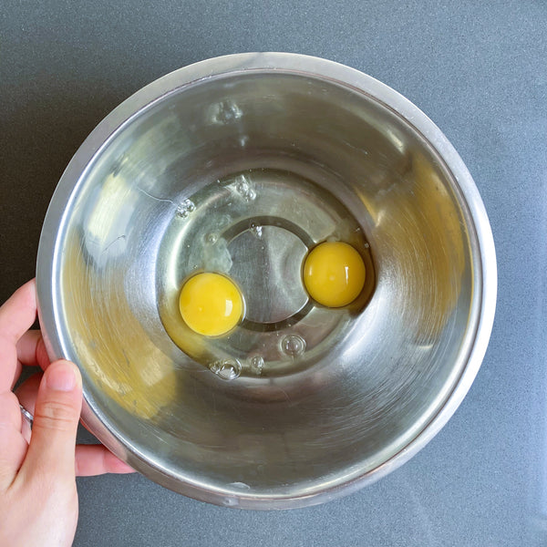 cracking the eggs into a bowl