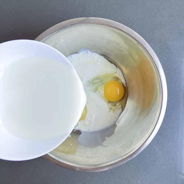 pouring milk into the eggs