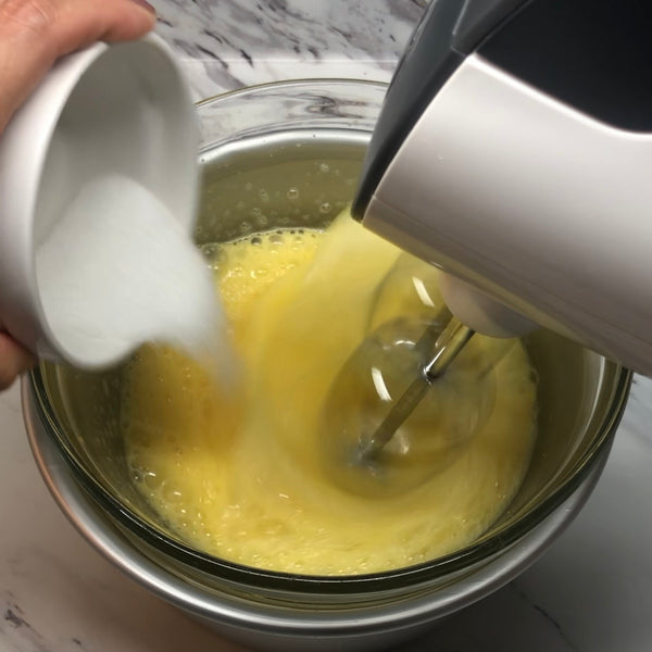 adding sugar to the eggs