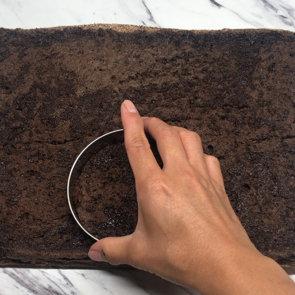 using a mold to cut out circles in the sheet cake