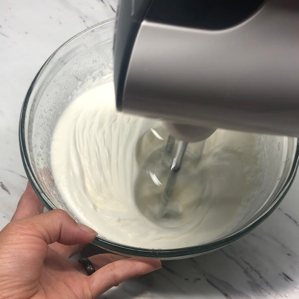 whipping the cream with a hand mixer