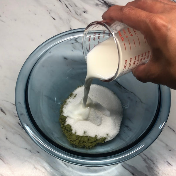 adding the matcha powder, sugar, and milk into a bowl