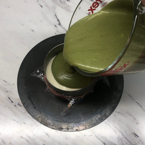 adding a layer of the matcha mousse on top of the white chocolate mousse