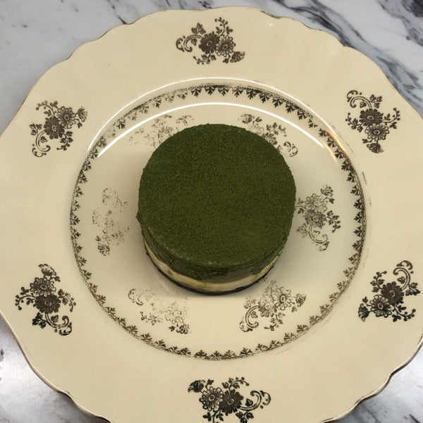 putting the matcha mousse cake on a plate