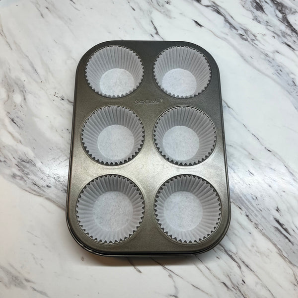 lining a muffin tin with liners