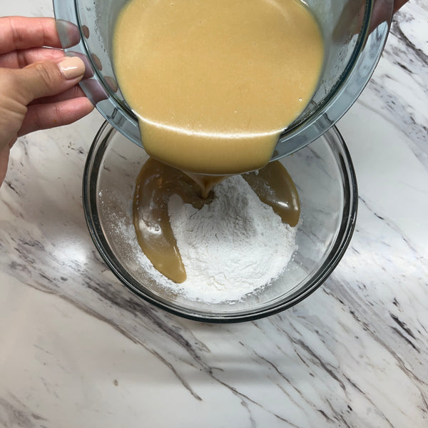 adding the wet ingredients to the dry ingredients