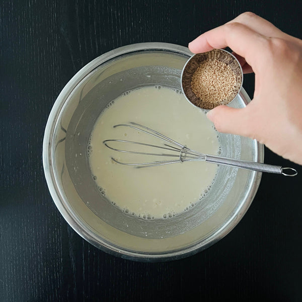 adding dashi stock powder to the negiyaki batter