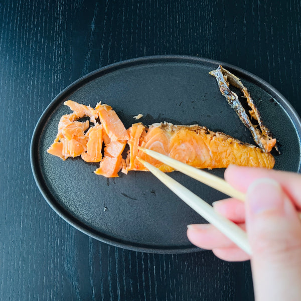 shredding the cooked salmon with chopsticks