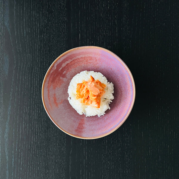 adding the salmon on top of the rice