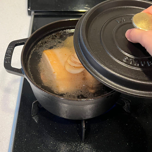 covering the pork belly and simmering for an hour