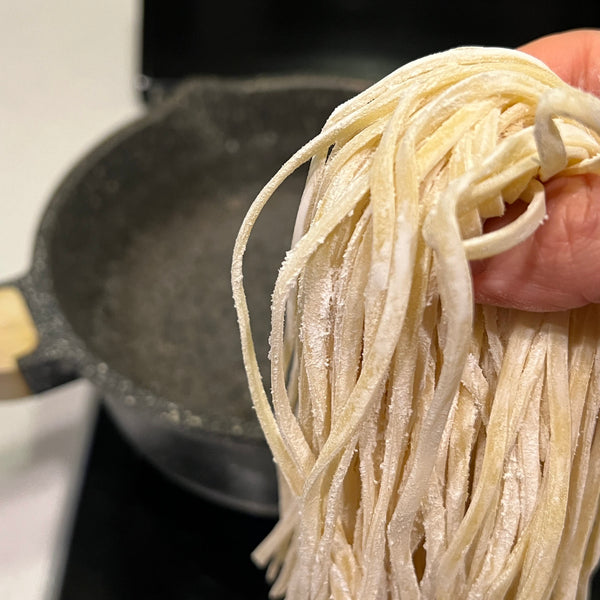 adding the okinawa soba noodles to a pot of boiling water