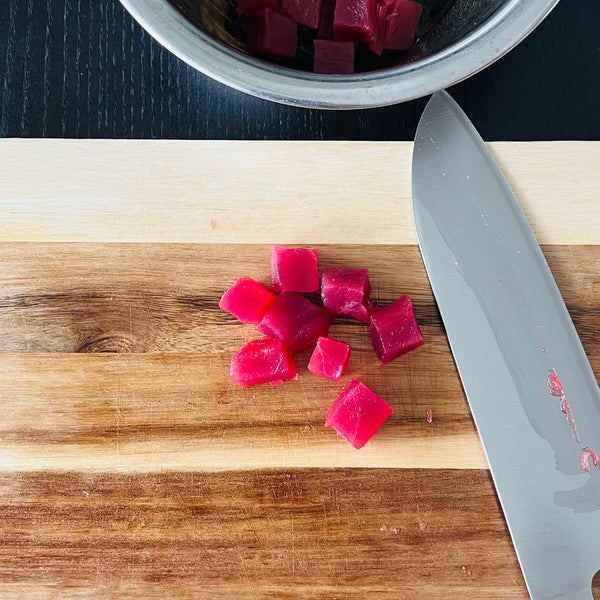 cutting the tuna into small cubes and then adding it into the seasoning mixture