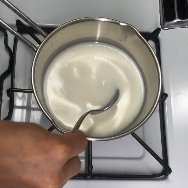 mixing the sugar and milk together with a spoon