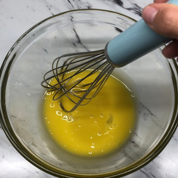 mixing the eggs in a bowl