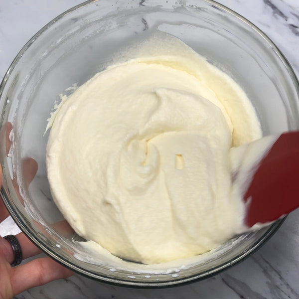 mixing both mixtures together with a rubber spatula