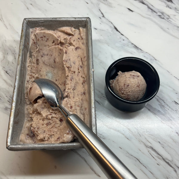 putting a scoop of red bean ice cream in a bowl